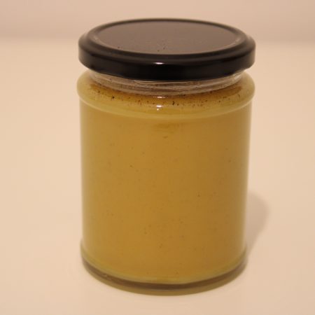 345g glass jar of raw honey blended with vibrant turmeric powder, label clearly visible