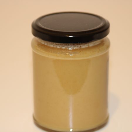 345g glass jar of locally harvested honey infused with real ginger, showing label and golden color